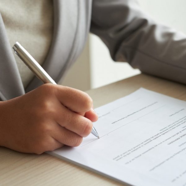 cropped-anonymous-business-woman-checking-agreement-before-signing (1)